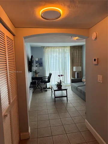 a view of a room with furniture and a chandelier