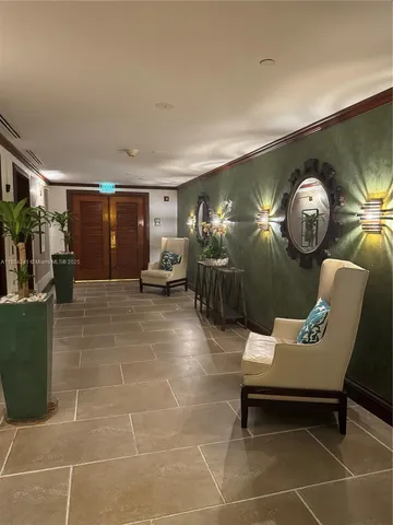 a lobby with furniture and rug