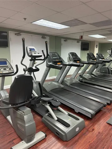 a kitchen with a sink a stove top oven and white cabinets