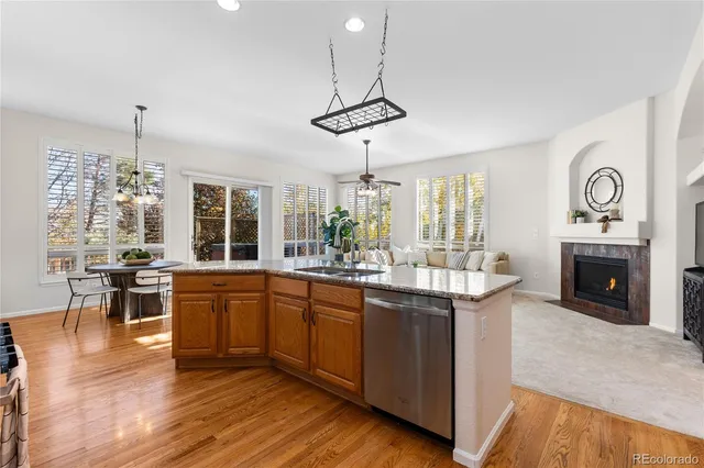 a kitchen with stainless steel appliances granite countertop a stove and a wooden floors