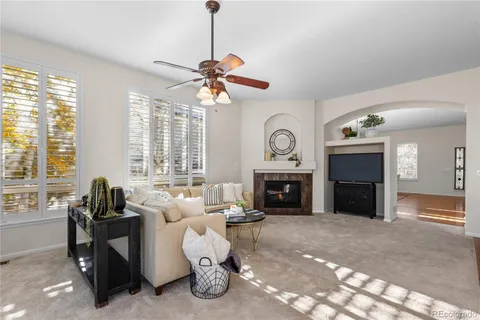 a living room with furniture a window and a fireplace