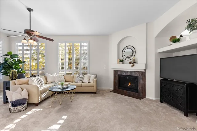 a living room with furniture and a fireplace