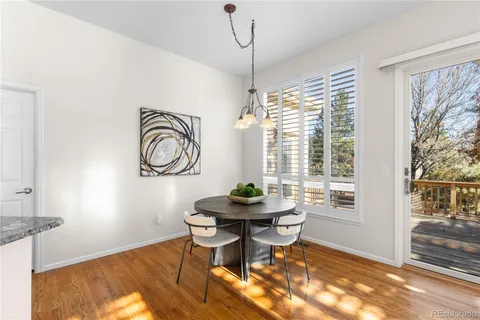 a dining room with furniture a rug and wooden floor