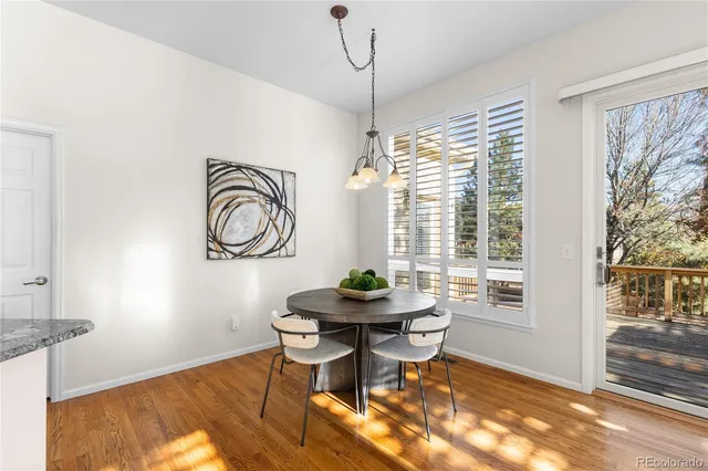 a dining room with furniture a rug and wooden floor