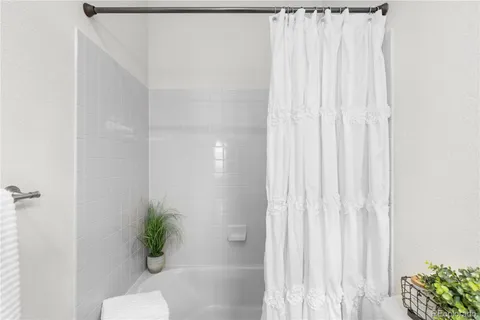 a bathroom with a shower curtain and a window
