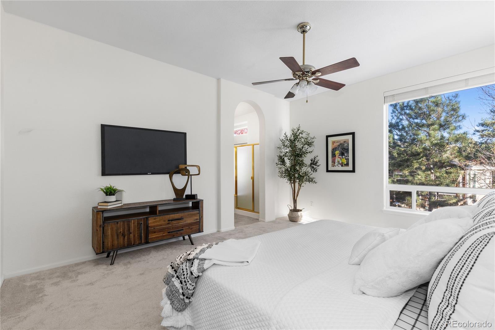 8166 Wetherill Circle Castle Pines, CO 80108 - Photo 27 of 49 a bedroom with a bed and a flat screen tv