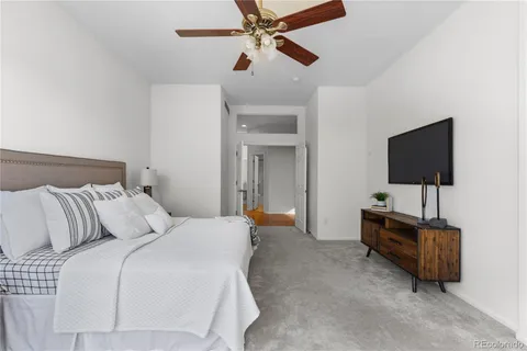 a bedroom with a bed and a flat screen tv