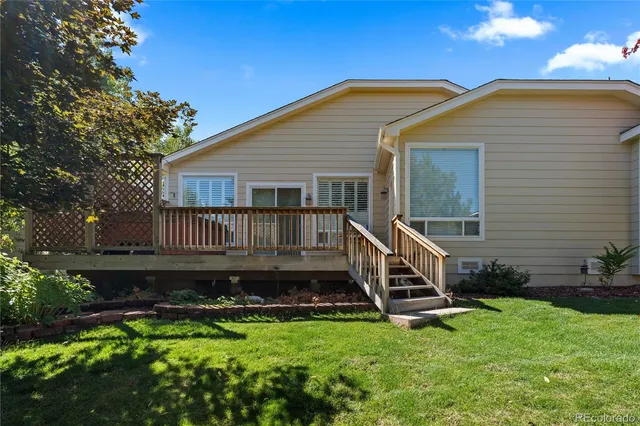 a view of a house with backyard and sitting area
