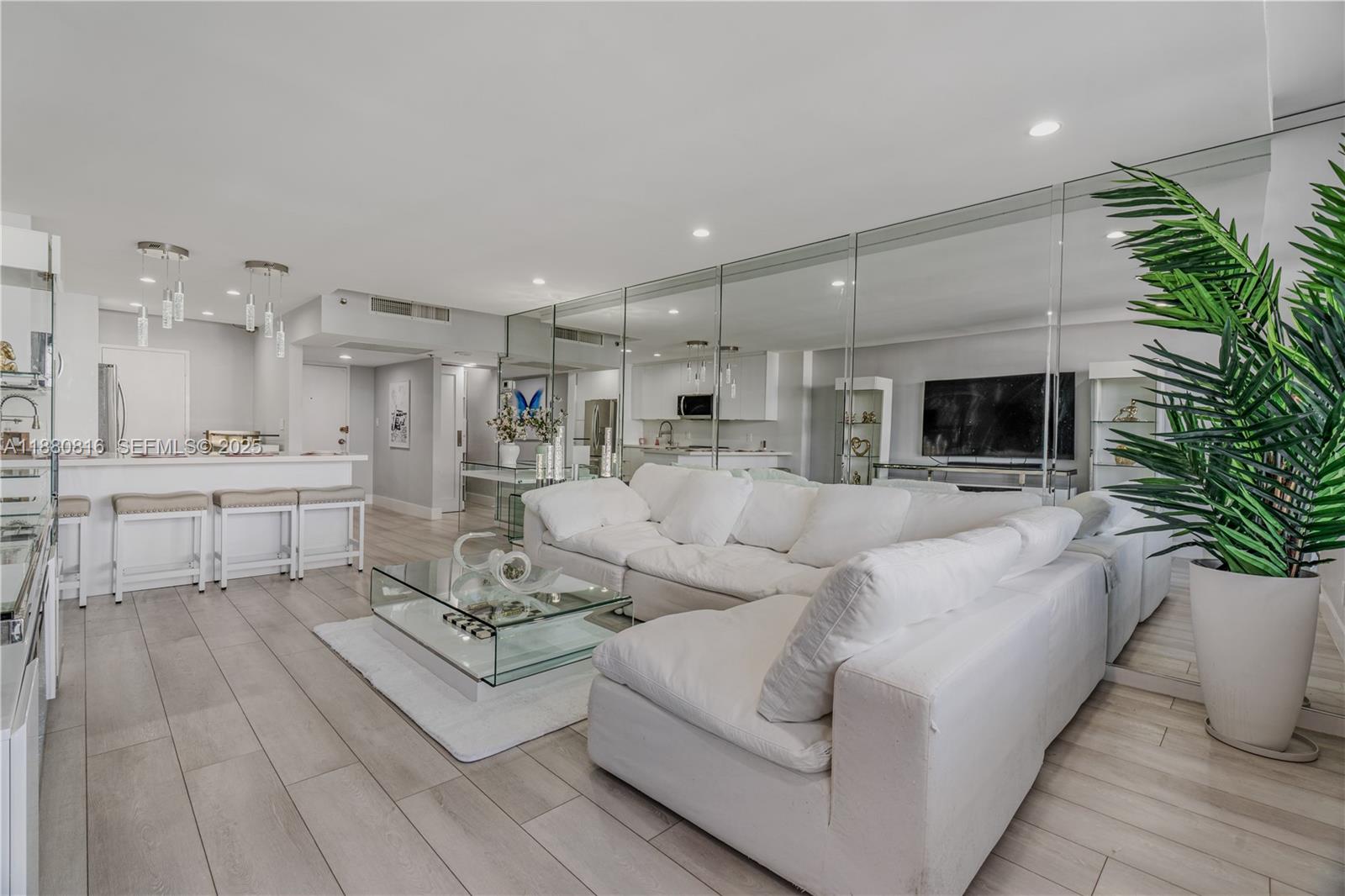 100 Lincoln Road, Unit 323 Miami Beach, FL 33139 - Photo 13 of 59 a living room with furniture a flat screen tv and a fireplace