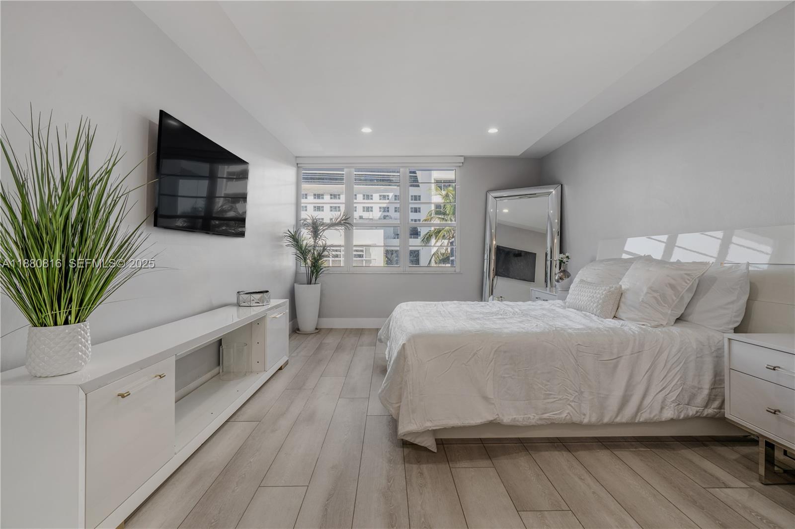 100 Lincoln Road, Unit 323 Miami Beach, FL 33139 - Photo 21 of 59 a spacious bedroom with a bed and a flat screen tv