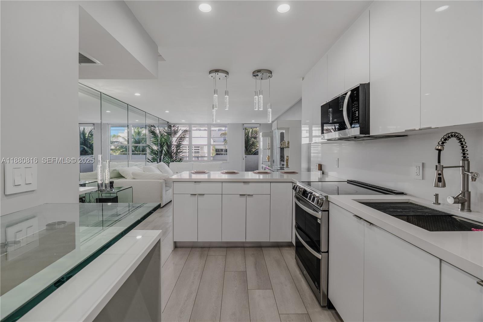 100 Lincoln Road, Unit 323 Miami Beach, FL 33139 - Photo 34 of 59 a kitchen with a sink stove top oven and cabinets