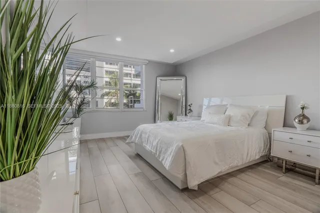 a bedroom with furniture and a flat screen tv