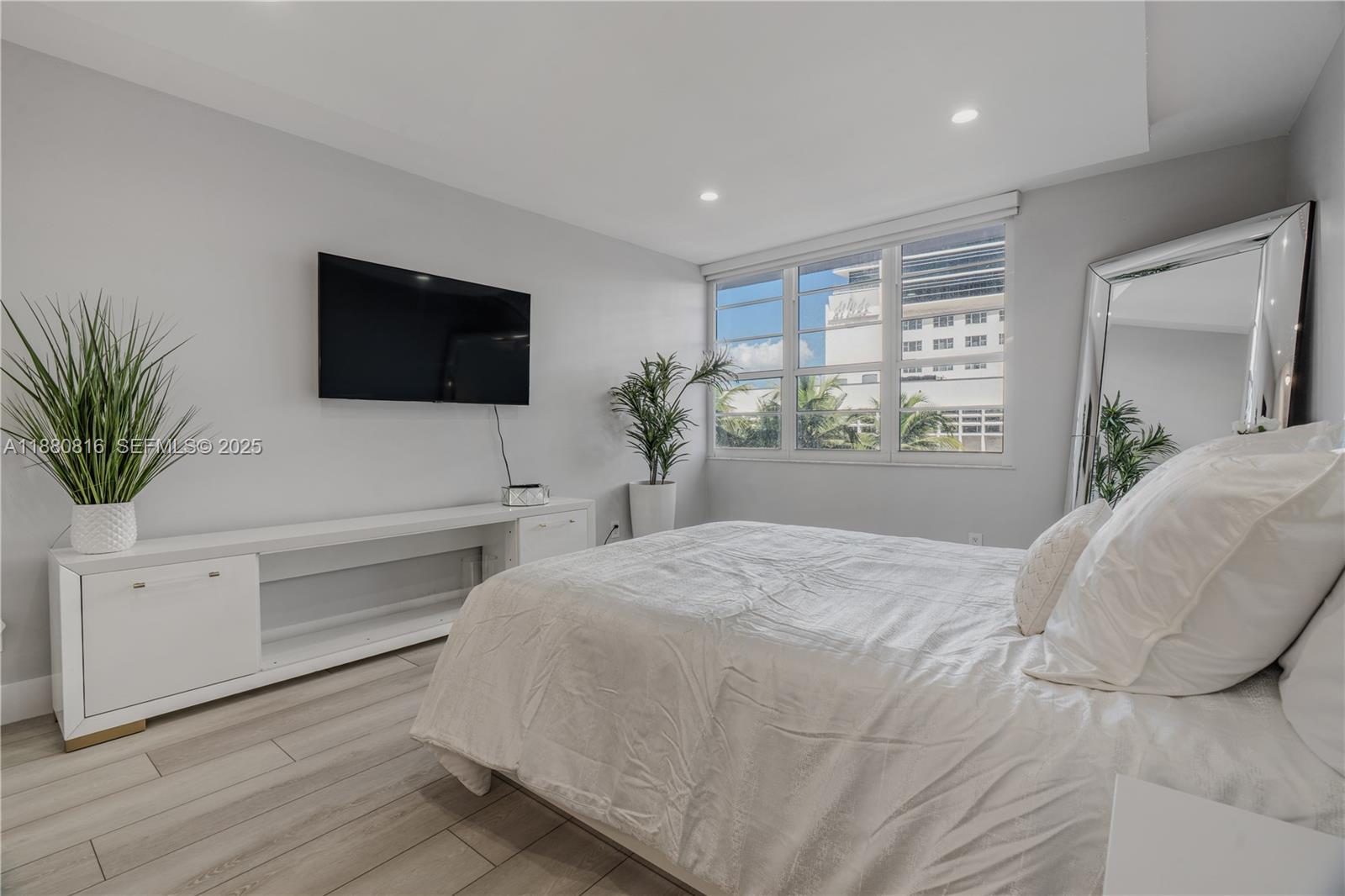 100 Lincoln Road, Unit 323 Miami Beach, FL 33139 - Photo 43 of 59 a bedroom with a large bed and a flat screen tv