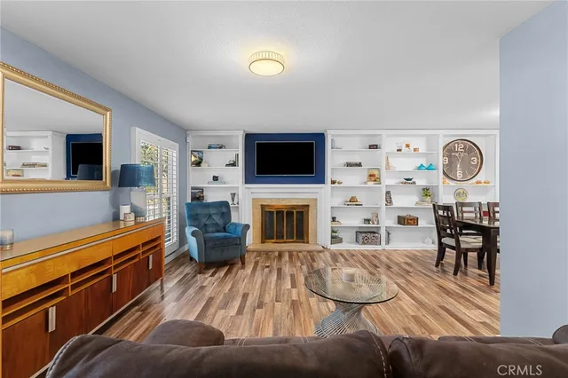 a living room with fireplace furniture and a flat screen tv