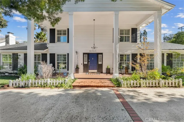 front view of a brick house with a large windows