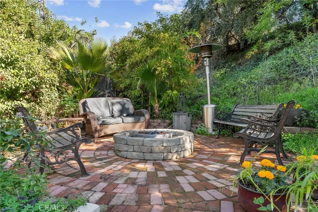 a view of a patio with table and chairs and potted plants