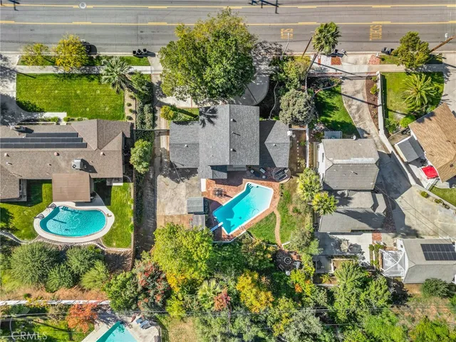 an aerial view of a house with a yard and a fountain