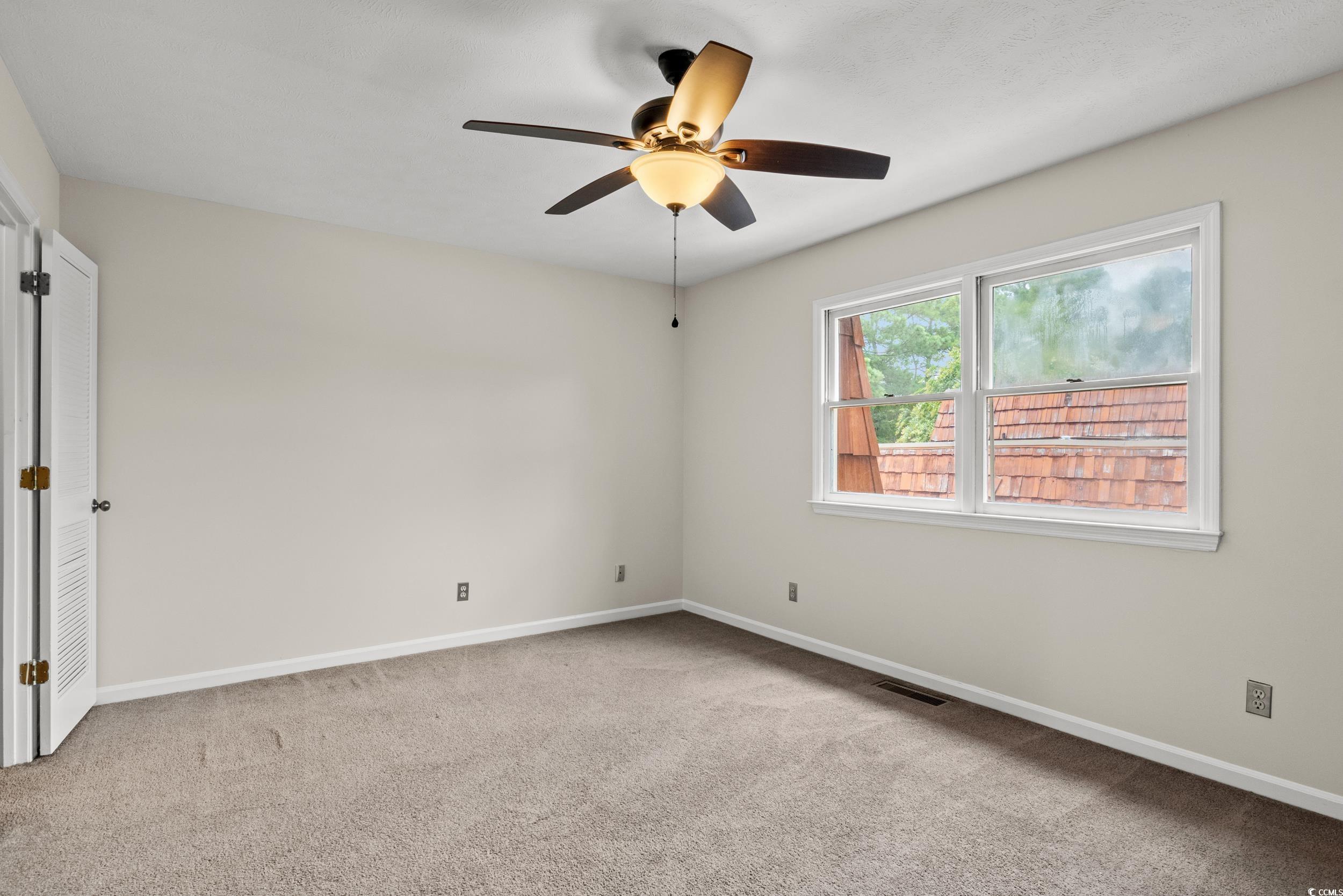 1025 Carolina Road, Unit S2 Conway, SC 29526 - Photo 13 of 27 Spare room with carpet floors and ceiling fan