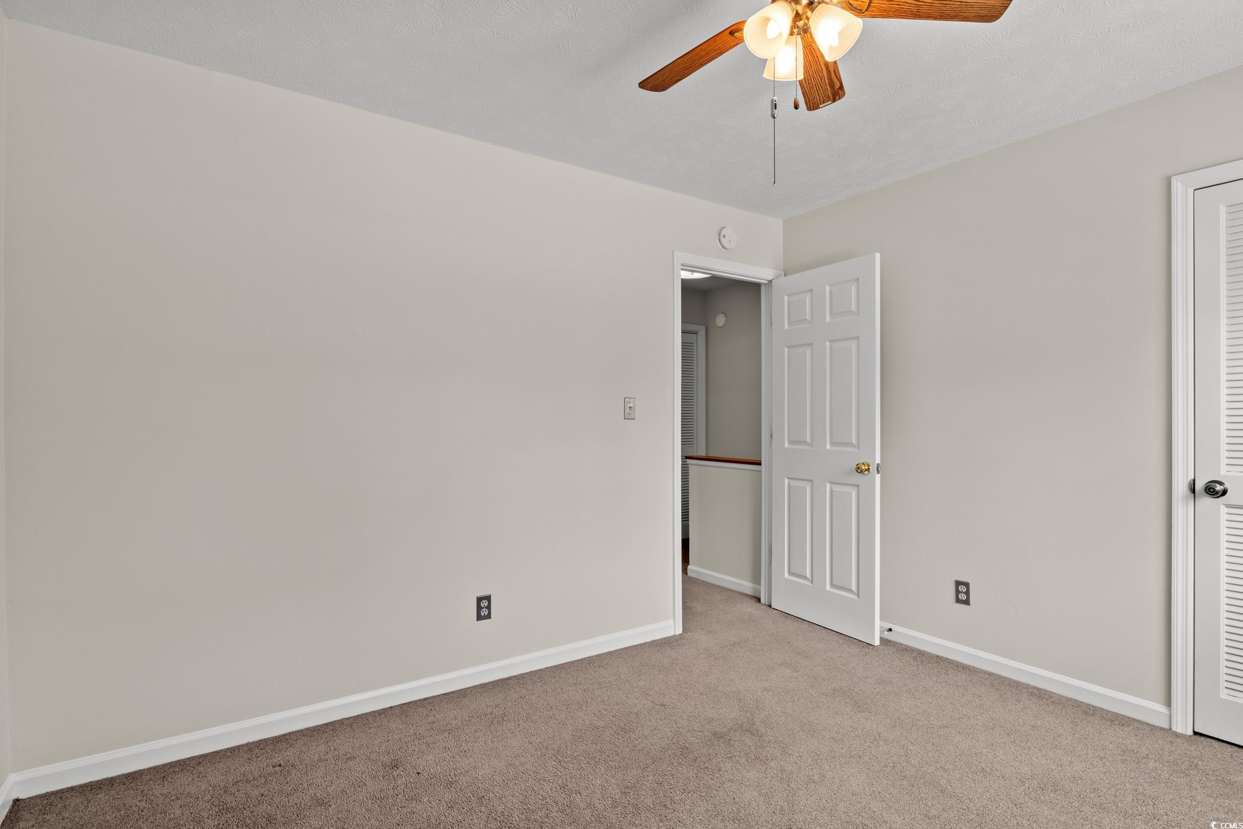 1025 Carolina Road, Unit S2 Conway, SC 29526 - Photo 18 of 27 Empty room with light carpet and ceiling fan