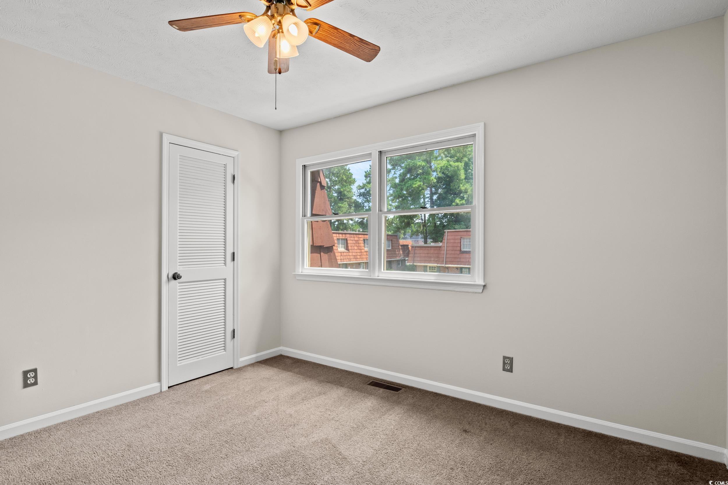 1025 Carolina Road, Unit S2 Conway, SC 29526 - Photo 20 of 27 Carpeted empty room with ceiling fan
