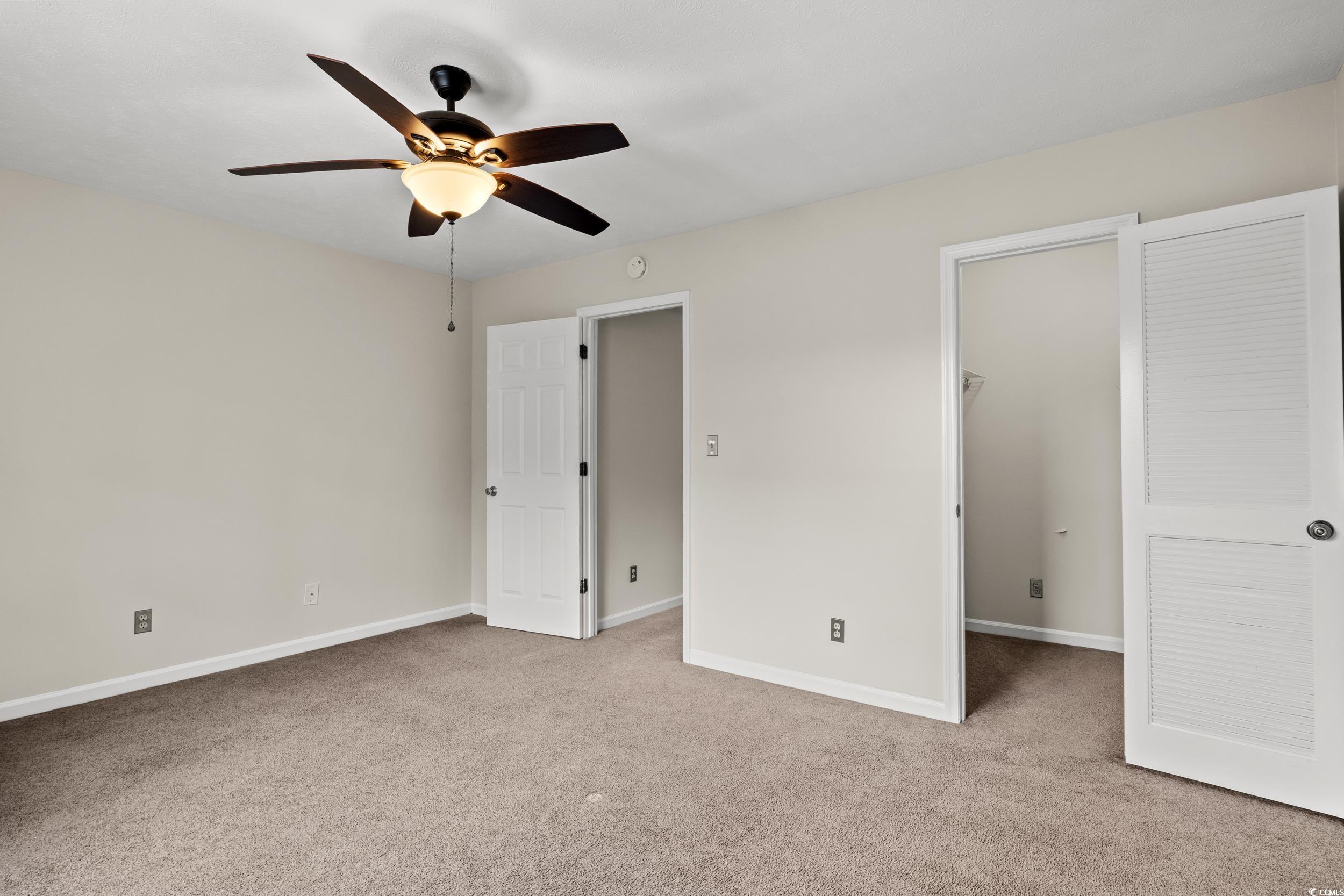 1025 Carolina Road, Unit S2 Conway, SC 29526 - Photo 21 of 27 Unfurnished bedroom featuring ceiling fan, carpet,