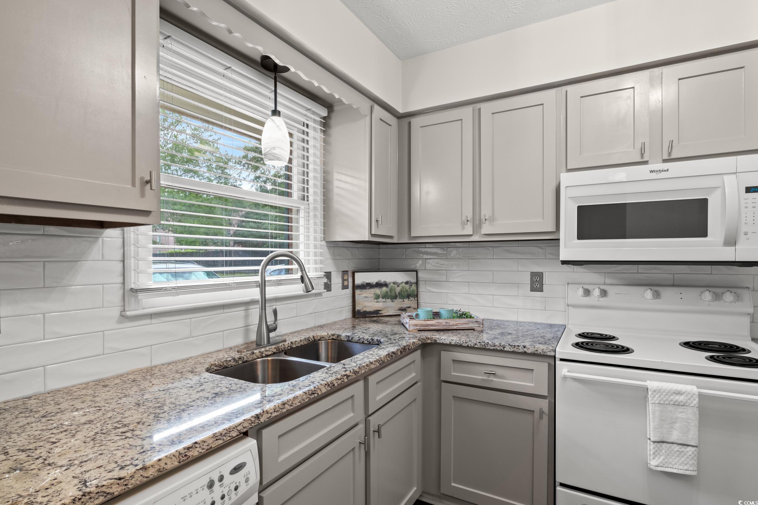 1025 Carolina Road, Unit S2 Conway, SC 29526 - Photo 3 of 27 Kitchen with pendant lighting, white appliances, s