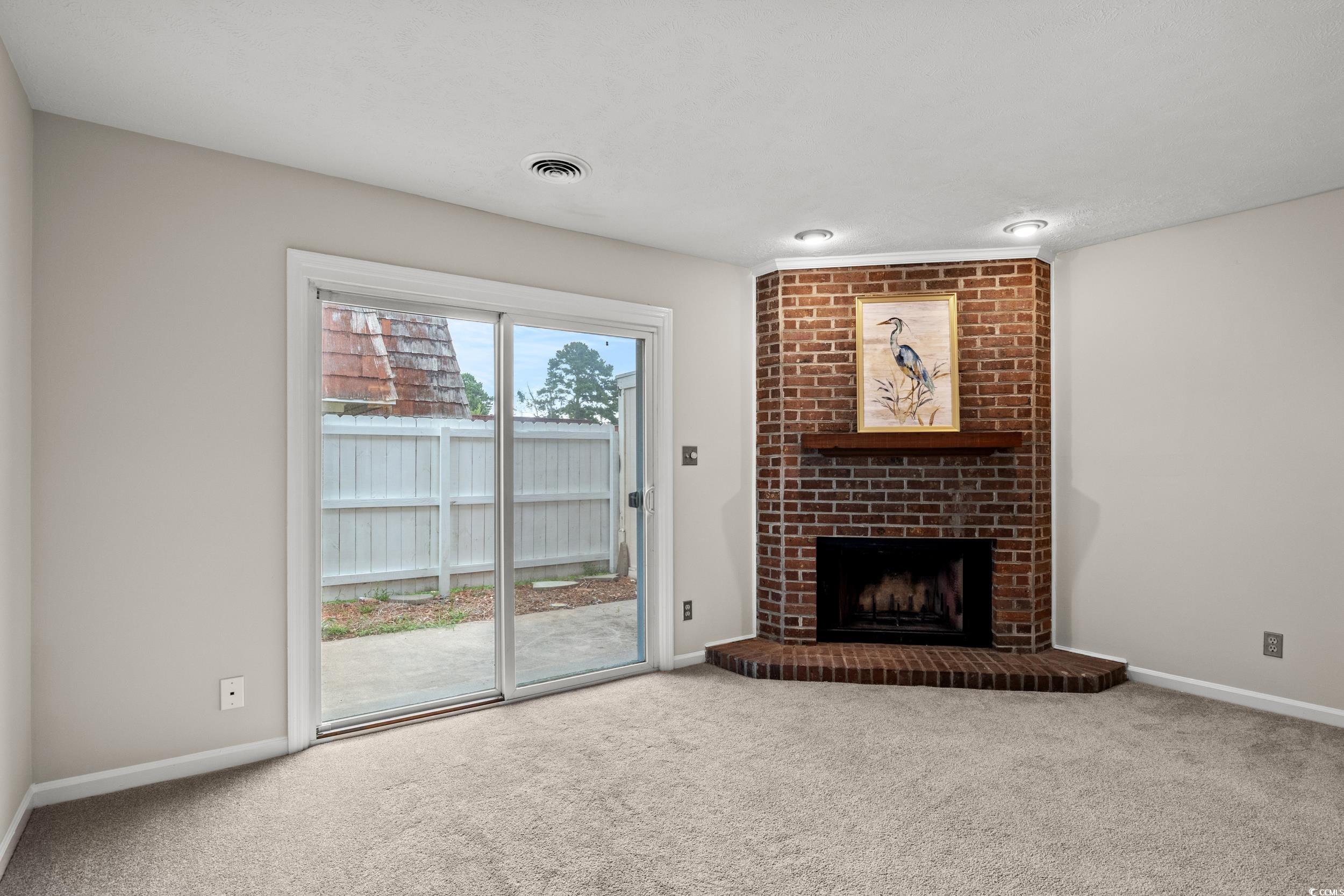 1025 Carolina Road, Unit S2 Conway, SC 29526 - Photo 6 of 27 Unfurnished living room with carpet floors, brick