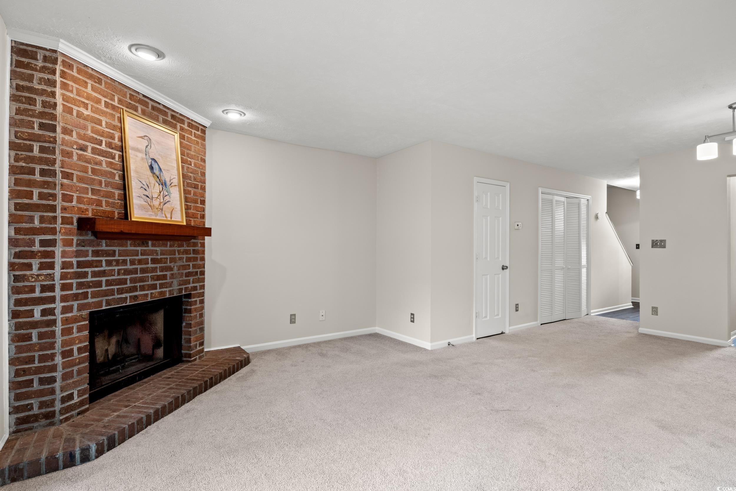 1025 Carolina Road, Unit S2 Conway, SC 29526 - Photo 7 of 27 Unfurnished living room with carpet flooring, a br