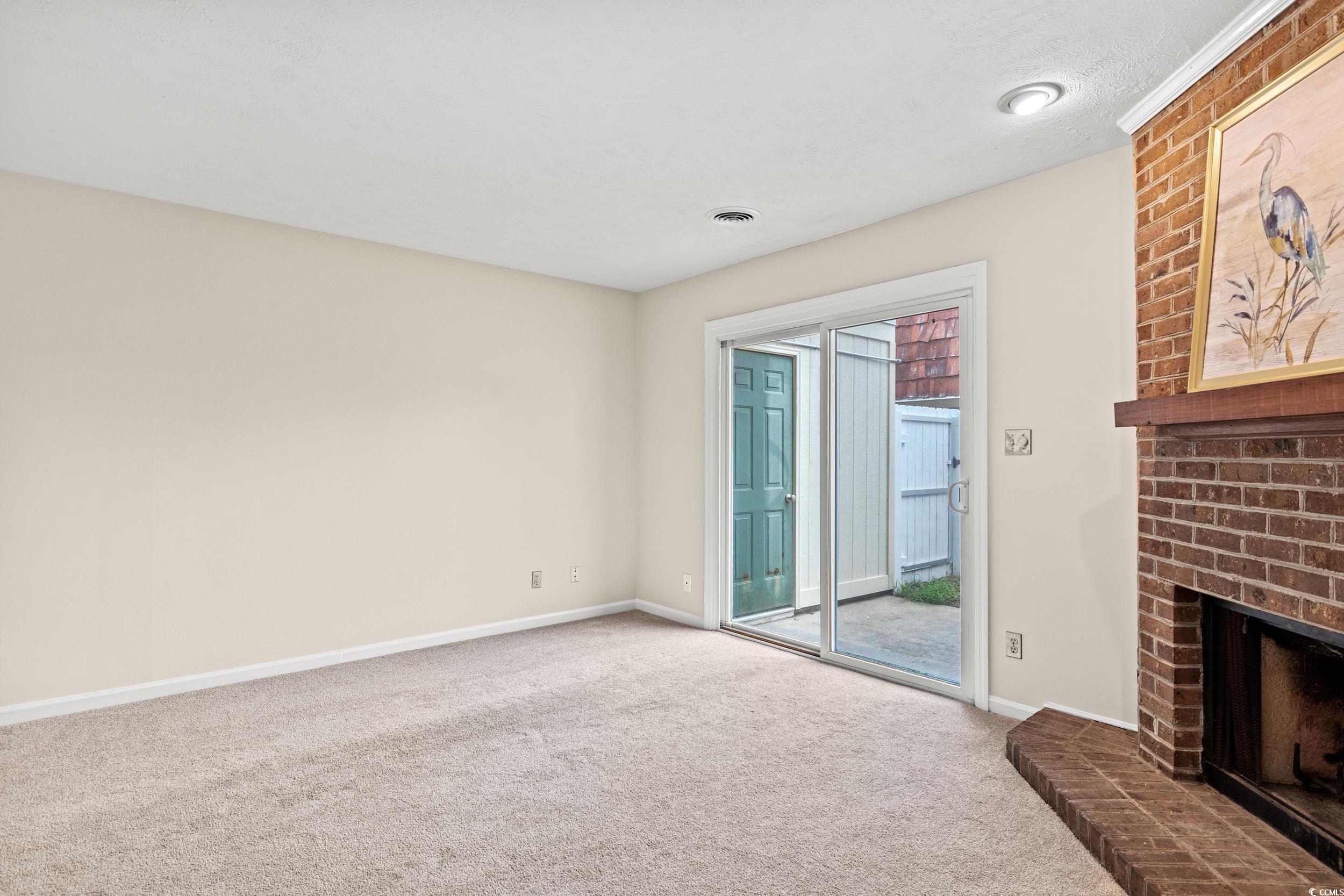 1025 Carolina Road, Unit S2 Conway, SC 29526 - Photo 8 of 27 Unfurnished living room with a brick fireplace, br