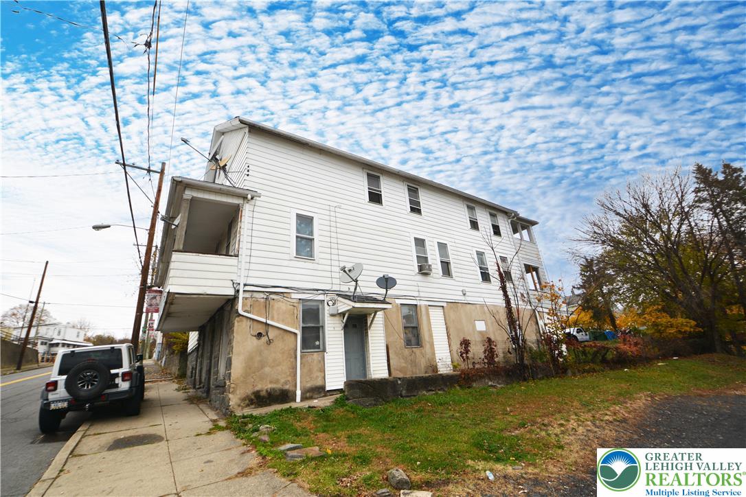 745 Main Street Kingston, PA 18704 - Photo 3 of 15 a view of a white house with a yard
