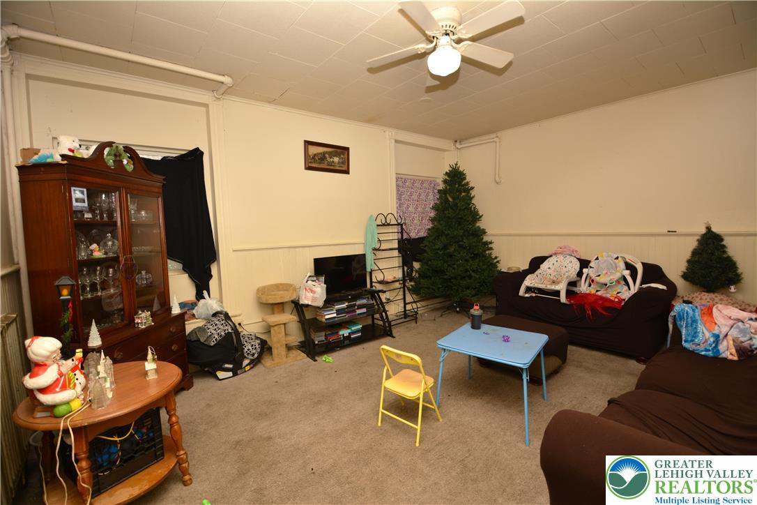 745 Main Street Kingston, PA 18704 - Photo 4 of 15 a living room with furniture and a flat screen tv with wooden floor