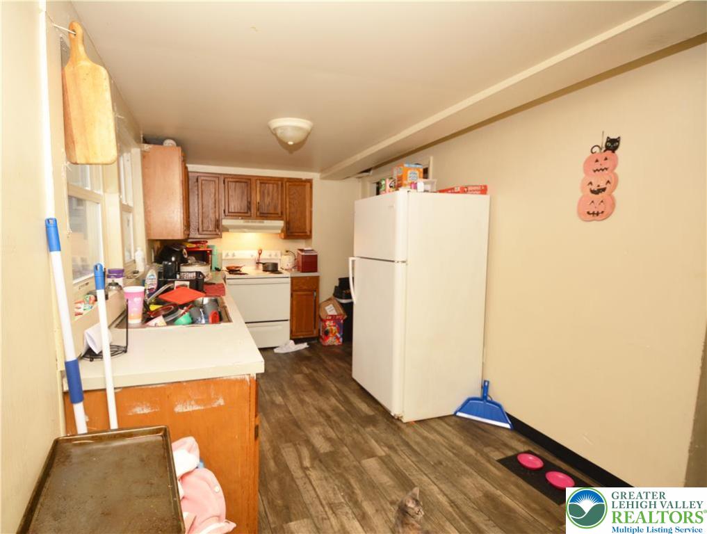 745 Main Street Kingston, PA 18704 - Photo 7 of 15 a kitchen with refrigerator and white cabinets