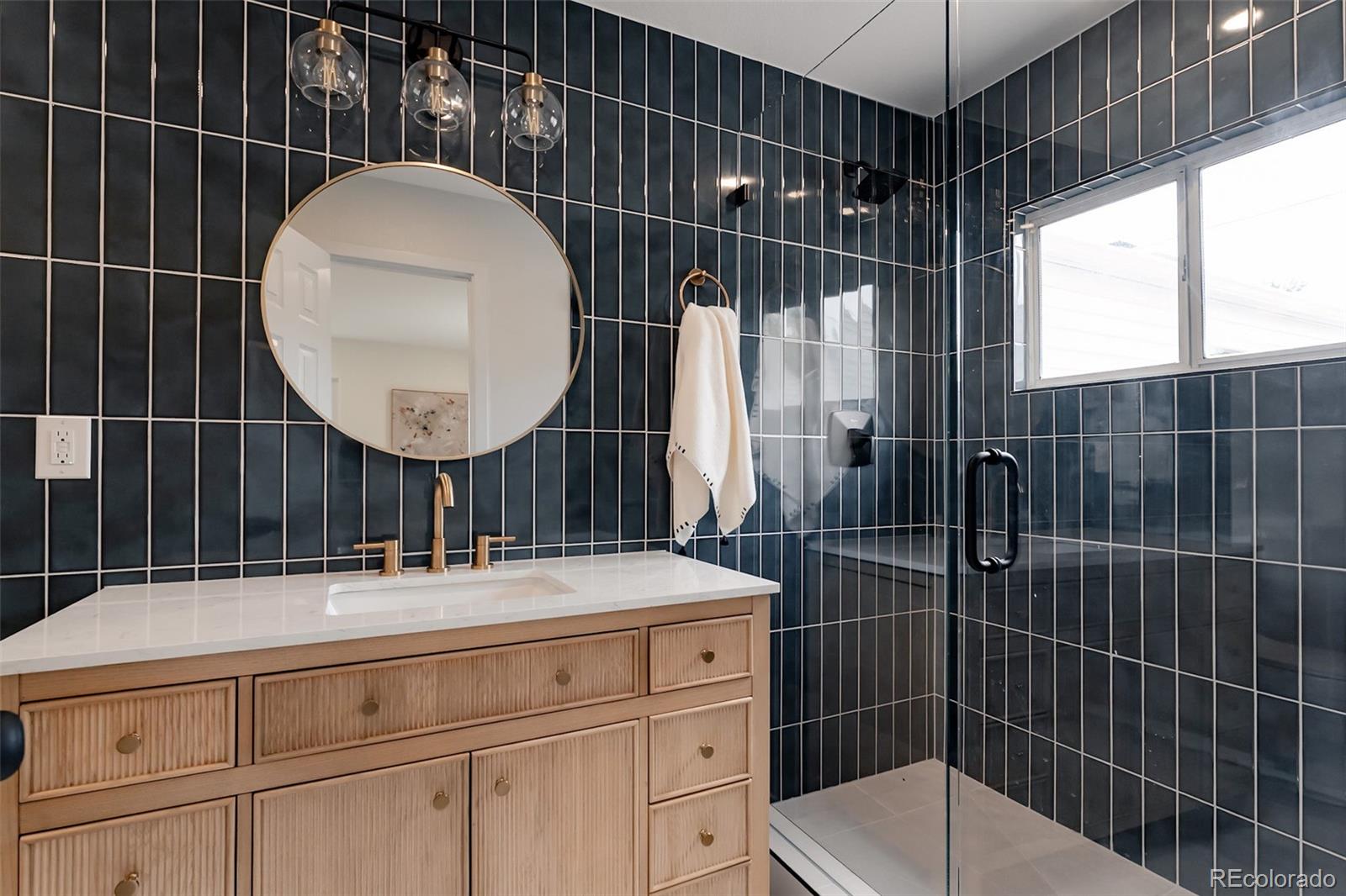 1279 South Raritan Street Denver, CO 80223 - Photo 18 of 25 a bathroom with a sink toilet and shower