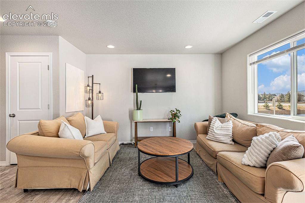 2940 Magic Carpet Loop Colorado Springs, CO 80916 - Photo 5 of 21 a living room with furniture and a flat screen tv