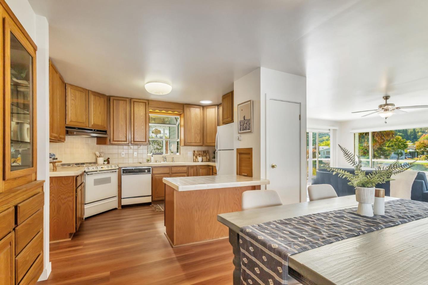 225 Mt Hermon Road, Unit 81 Scotts Valley, CA 95066 - Photo 9 of 38 a large kitchen with cabinets wooden floor and a dining table