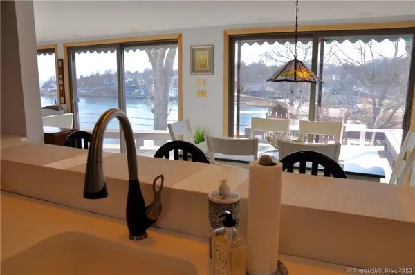 a kitchen with a table chairs and a window