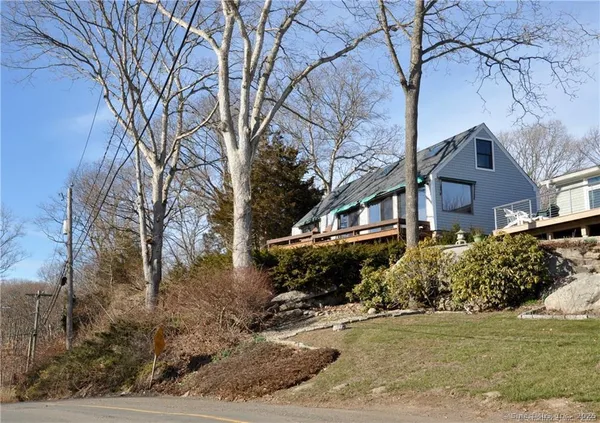 a front view of a house with a yard covered with snow