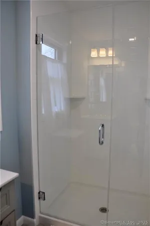 a bathroom with a sink mirror and a window