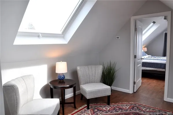 a living room with furniture and a lamp