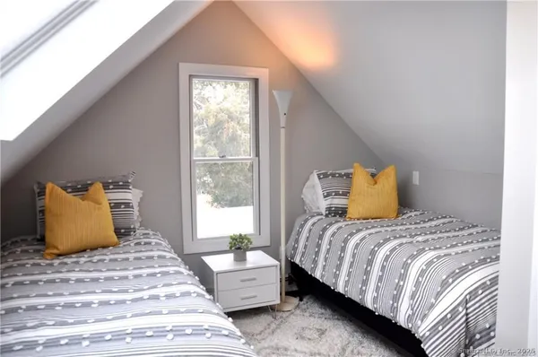 a bedroom with a bed and window