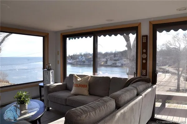 a living room with furniture and a floor to ceiling window
