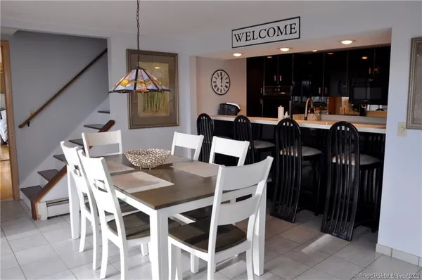 a dining room with furniture and window