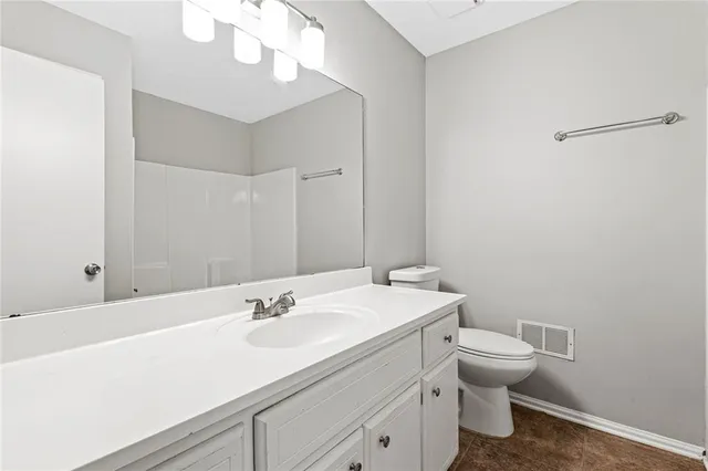 a bathroom with a sink a toilet and a mirror