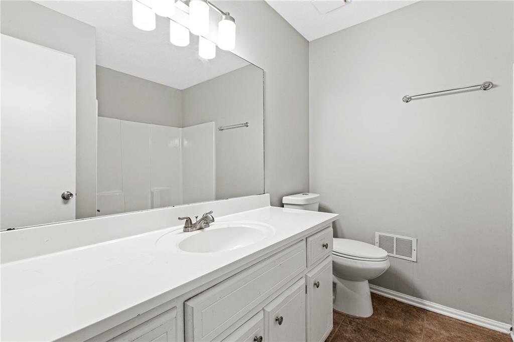 1735 Charmeth Road Lithonia, GA 30058 - Photo 14 of 27 a bathroom with a sink a toilet and a mirror