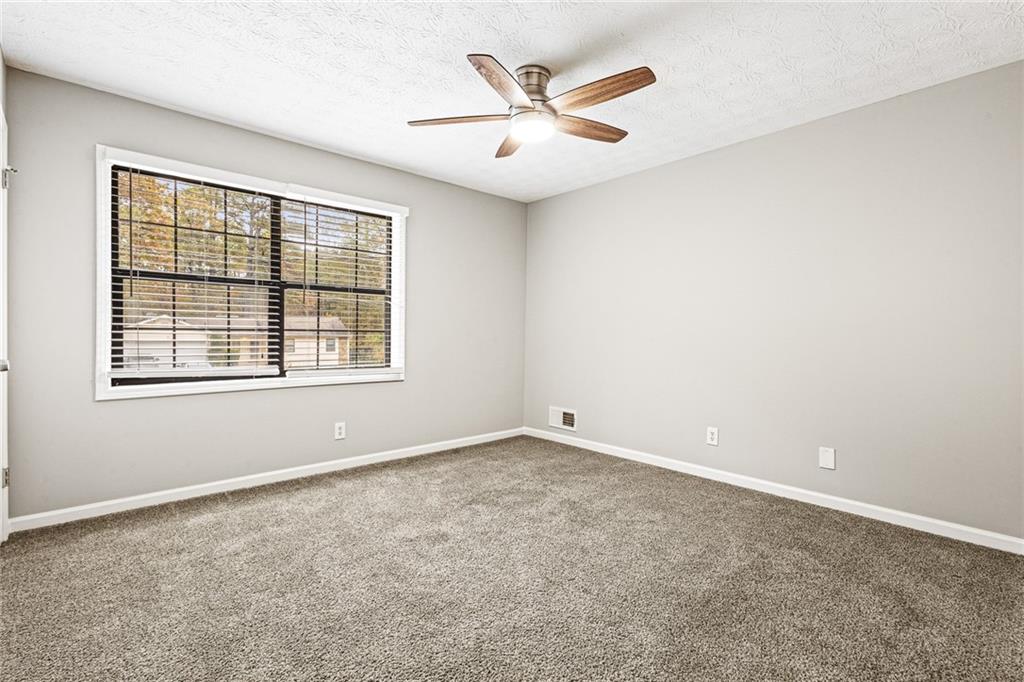 1735 Charmeth Road Lithonia, GA 30058 - Photo 16 of 27 an empty room with a window