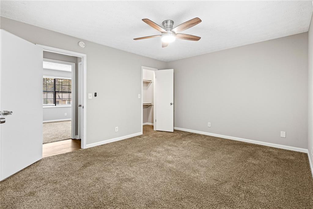 1735 Charmeth Road Lithonia, GA 30058 - Photo 18 of 27 an empty room with closet and windows