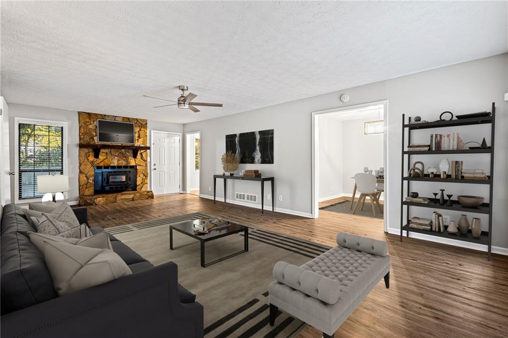 1735 Charmeth Road Lithonia, GA 30058 - Photo 2 of 27 a living room with furniture and a flat screen tv