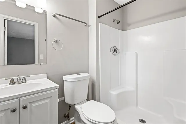 a white toilet sitting next to a bathroom sink