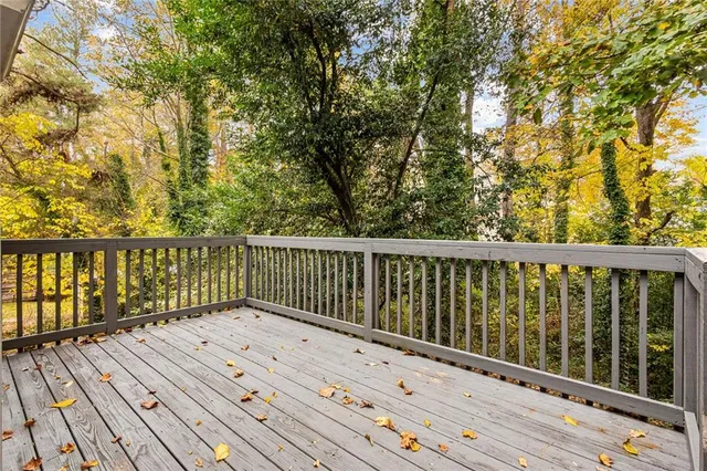 a view of balcony with wooden floor and fence
