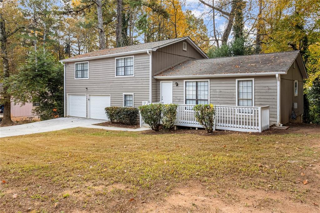1735 Charmeth Road Lithonia, GA 30058 - Photo 27 of 27 a view of a house with a yard and garage